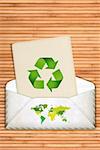 Ecology concept with recycling symbol over wooden background with copy space