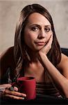 Calm young white woman with hand on cheek