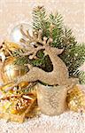 Christmas decoration with golden deer and spruce branch.