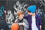 Jungen mit Basketball von Graffiti bedeckt Wand, Mannheim, Baden-Württemberg, Deutschland