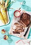 Flank Steak, Corn on the Cob and Glasses of Iced Tea