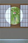 Wind chime and green maple leaves