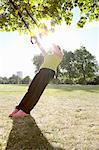 Woman using exercise straps outdoors