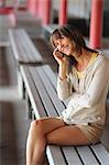 Woman talking on cell phone on bench