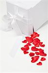 Satin hearts spilling from gift box