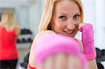 Boxer holding fists up in gym