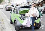 Woman loading shopping bags in car