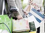 Couple loading shopping bags in car