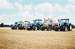 Tractors parked in tilled crop field