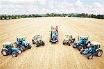 Tractors parked in tilled crop field