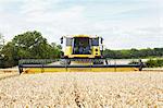 Harvesters working in crop field