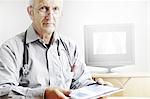 Doctor using tablet computer in office