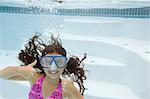 Girl giving thumbs up underwater