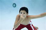 Boy holding nose underwater