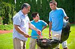 Père et fils, grillades en plein air