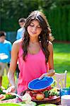 Woman serving herself food outdoors