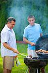 Father and son grilling outdoors