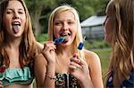 Girls eating ice lollies