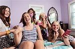 Girls using smartphone in bedroom