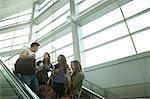 Friends travelling on escalator