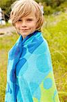 Boy wrapped in a towel outdoors