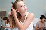 Teenage girl brushing her hair