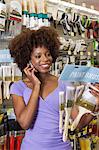 African American woman buying paint Brushes at hardware store