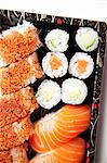 Close-up of sushi food on tray against white background