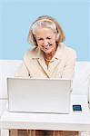 Cheerful senior woman using laptop for video calling