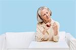 Senior woman filing nails at home