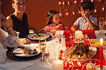 Family gathered around table for Christmas dinner