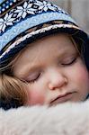 Toddler girl wearing knit hat sleeping, portrait