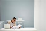 Businesswoman reading documents in office