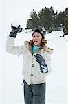 Preteen girl throwing snowball
