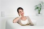 Young woman listening to MP3 player with eyes closed