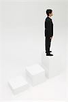 Businessman standing on highest step