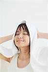 Portrait of a Japanese woman drying her hair