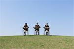 Japanese schoolgirls studying at their desks on the top of a hill