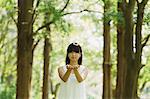 Asian woman in a white dress forest bathing