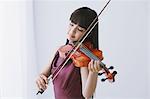 Asian woman in a purple dress playing the violin