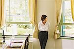 Japanese woman in a white shirt looking out of the window