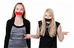 Two beautiful girls with their mouths taped with tape