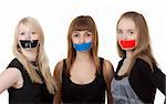Three beautiful girls with their mouths taped with tape