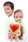 Healthy eating kids concept - children holding apple with heart sign