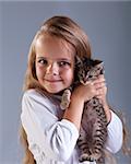 Portrait of adorable little girl and her kitten