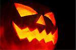 Detail of a scary halloween pumpkin on dark background