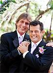 Handsome gay couple pose for protrait on their wedding day.