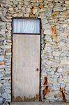 Wood door and stone of wall in the rustic city