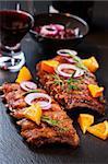 BBQ spare ribs marinated in orange sauce with herbs and wine