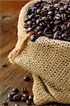 linen bag with coffee beans on wooden table